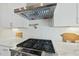 Kitchen detail showing gas cooktop, range hood, and herringbone backsplash at 148 Hidden Creek Ct, Pittsboro, NC 27312