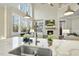Modern kitchen island with white cabinets, quartz countertops and stainless steel appliances at 148 Hidden Creek Ct, Pittsboro, NC 27312