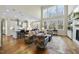 Spacious living room features high ceilings, hardwood floors, and a wall of windows at 148 Hidden Creek Ct, Pittsboro, NC 27312