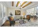 Spacious living room with hardwood floors, exposed beams, and a cozy sitting area at 148 Hidden Creek Ct, Pittsboro, NC 27312
