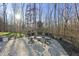 Cozy patio seating area with fire pit and stone fireplace at 148 Hidden Creek Ct, Pittsboro, NC 27312