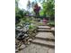 Landscaped stone steps and cascading waterfall at 148 Hidden Creek Ct, Pittsboro, NC 27312