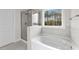 Main bathroom with walk-in shower and garden tub at 154 Tennyson Dr, Garner, NC 27529