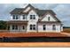 Two-story home with large windows and a classic design, under construction at 154 Tennyson Dr, Garner, NC 27529