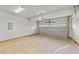 Attached garage with open overhead door and concrete floor at 154 Tennyson Dr, Garner, NC 27529