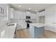 Modern kitchen with white cabinets, quartz countertops and an island at 154 Tennyson Dr, Garner, NC 27529