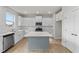 Modern kitchen featuring white cabinets, quartz countertops and an island at 154 Tennyson Dr, Garner, NC 27529