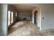 Unfinished living room featuring open archways to other rooms and lots of natural light at 154 Tennyson Dr, Garner, NC 27529