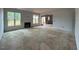Spacious living room awaiting transformation, featuring large windows, fireplace, and plenty of natural light at 154 Tennyson Dr, Garner, NC 27529
