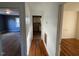 Long hallway with wood floors connecting bedrooms at 160 S Bullock St, Henderson, NC 27536