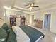 Main bedroom with king bed, built-in shelves, and ensuite bathroom access at 1709 Chestnut Falls Rd, Wendell, NC 27591