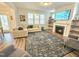 Inviting living room showcasing a cozy fireplace and a large window, perfect for relaxation at 1709 Chestnut Falls Rd, Wendell, NC 27591