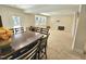 Open-concept living space showcasing a dining table and seating area with a large window at 1709 Chestnut Falls Rd, Wendell, NC 27591