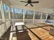 Spacious screened porch with wooden flooring, table and chairs, and hammock at 1709 Chestnut Falls Rd, Wendell, NC 27591