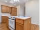 Kitchen boasts an island, oak cabinets, and a white stove at 250 Kentview Dr, Pittsboro, NC 27312