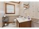 Clean bathroom with single sink vanity and neutral color scheme at 253 Ronald Tharrington Rd, Louisburg, NC 27549