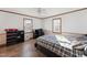Well-lit bedroom with a plaid bedspread and built-in shelving at 253 Ronald Tharrington Rd, Louisburg, NC 27549