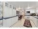 White kitchen cabinets, patterned flooring, and a breakfast bar at 253 Ronald Tharrington Rd, Louisburg, NC 27549