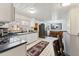 Galley kitchen with white cabinets, dark countertops, and stainless steel appliances at 253 Ronald Tharrington Rd, Louisburg, NC 27549