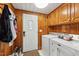 Laundry room with washer, dryer, cabinets, and built in storage at 253 Ronald Tharrington Rd, Louisburg, NC 27549