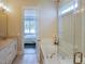 Bathroom with a bathtub, granite countertop, and a view to the bedroom at 2790 Farmhouse Dr, Apex, NC 27502