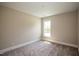 Simple bedroom with carpeted floors and a large window at 2790 Farmhouse Dr, Apex, NC 27502