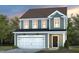 Two-story house with gray siding, white garage door, and landscaping at 2790 Farmhouse Dr, Apex, NC 27502