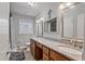 Bathroom featuring double sinks, granite countertops, and vanity with lots of storage at 302 S Pine St, Benson, NC 27504