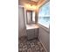 This bathroom features new flooring, a vanity with drawers and cabinets, and neutral paint at 302 S Pine St, Benson, NC 27504