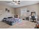This bedroom features a ceiling fan, one window, neutral walls, and coordinated study and decor at 302 S Pine St, Benson, NC 27504