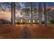 Brick ranch home with walkway, landscaping, and mature trees at 302 S Pine St, Benson, NC 27504