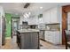 Modern kitchen with granite countertops, an island, and stainless steel appliances at 302 S Pine St, Benson, NC 27504