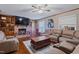 Spacious living room features a stone fireplace, built-in shelving, hardwood floors and comfortable seating at 302 S Pine St, Benson, NC 27504