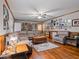 Spacious living room with hardwood floors, ample seating, and charming wall decor create a warm atmosphere at 302 S Pine St, Benson, NC 27504