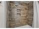 Tiled shower stall with rainfall showerhead and built-in shelves at 302 S Pine St, Benson, NC 27504