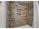 Modern shower features wood look tile, built in shelving and an adjustable shower head at 302 S Pine St, Benson, NC 27504