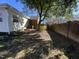Partly sunny backyard with a brick wall and mature trees at 307 Westfield Dr, Dunn, NC 28334