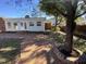 Charming backyard patio with brick flooring, large trees and rear exterior view at 307 Westfield Dr, Dunn, NC 28334