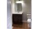 Well-lit bathroom with a single vanity, a modern mirror, and a toilet at 307 Westfield Dr, Dunn, NC 28334