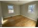 Bedroom with hardwood floors and two windows at 307 Westfield Dr, Dunn, NC 28334