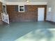 Covered carport with brick walls and painted floor at 307 Westfield Dr, Dunn, NC 28334