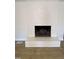 Close-up of brick fireplace with mantle and hearth, hardwood floors at 307 Westfield Dr, Dunn, NC 28334