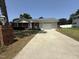 A house with a brick front and a concrete driveway leading to a two car garage at 307 Westfield Dr, Dunn, NC 28334