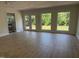 A living room with hardwood floors, three windows, and double glass doors at 307 Westfield Dr, Dunn, NC 28334