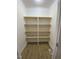 Walk-in pantry with custom built in wooden shelving for optimal kitchen storage at 307 Westfield Dr, Dunn, NC 28334
