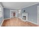 Living room with hardwood floors, wood-burning stove, and gray walls at 318 Asbury Church Rd, Sanford, NC 27330