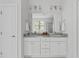 Bathroom featuring double vanity with granite counters and ample cabinet space under a large mirror at 3400 Amelia Grace Dr # 46, Fuquay Varina, NC 27526
