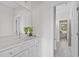 Bright bathroom with white cabinets, a large mirror, and a doorway view to a bedroom at 3400 Amelia Grace Dr # 46, Fuquay Varina, NC 27526