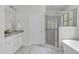 Bathroom featuring a soaking tub, glass-enclosed shower, and double vanity with stylish fixtures at 3400 Amelia Grace Dr # 46, Fuquay Varina, NC 27526