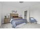 Bedroom featuring a doorway to a bright ensuite, natural light, wood furnishings and neutral colors at 3400 Amelia Grace Dr # 46, Fuquay Varina, NC 27526